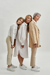 Wall Mural - Three female generations standing back to back