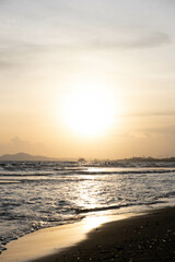 Wall Mural - Scenic shot of the waves hitting the beach during the sunset