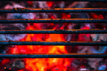 Poster - Closeup of a barbecue grill pit with flaming hot charcoal briquettes