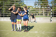 © KAMPUS - Young sporty women standing on football field. Sportswomen different uniforms standing before goals, shielding eyes from sun with hands. Sport, leisure, active lifestyle concept