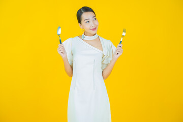 Wall Mural - Portrait beautiful young asian woman smile with spoon and fork