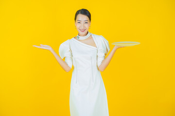 Wall Mural - Portrait beautiful young asian woman smile with empty plate dish