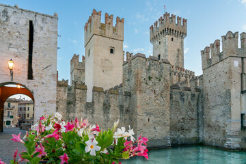 Wall Mural - Water castle of Sirmione, medieval fortress with tall towers on Garda Lake with gate