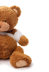 Wall Mural - medicine, healthcare and childhood concept - teddy bear toy with bandaged paw on white background