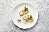 Fototapeta Tulipany - Plate with roasted fish served with herbs and sauce
