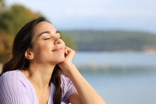 Woman Relaxing With Closed Eyes In The Mountain