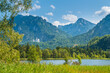 Germany, Beautiful nature landscape of mountains and forest surrounding schwansee lake water near castle schwangau and neuschwanstein in bavaria