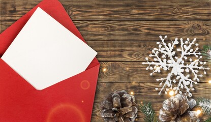 Poster - Composition with blank Christmas card and envelope on wooden table.