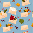 Envelopes with beautiful autumn leaves and letters. Vector seamless pattern on blue background.