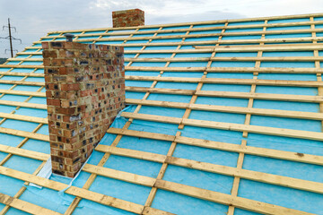 Wall Mural - Aerial view of a wooden roof frame of brick house under construction.