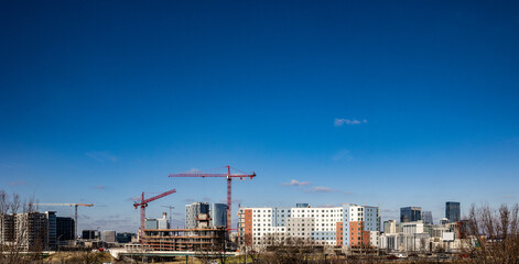 landscape panorama of cranes and other construction equipment building new properties in downtown na