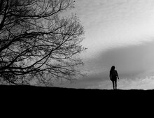 Black And White Silhouette Of Girl With Tree Against Sky