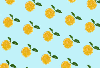 Wall Mural - Colorful fruit pattern of fresh orange slices on blue background. From top view