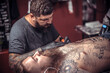 © Mr. Prof - Professional tattooer showing process of making a tattoo
