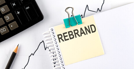 Poster - Stickers with pencils and notebook with text REBRAND on wooden background