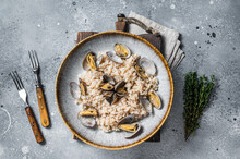 Italian Risotto With Clams In A Rustic Plate With Herbs. Gray Backgroud. Top View
