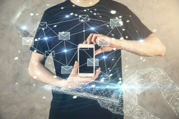 Poster - Double exposure of man's hands holding and using a digital device and envelop hologram drawing. E-mail concept.
