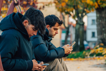 Poster - young people in autumn with mobile phone in the city