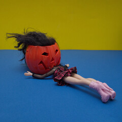 Canvas Print - Halloween pumpkin eats a girl minimalist composition on a blue-yellow background