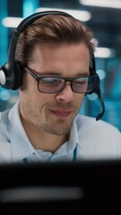 Fototapete - Vertical Screen. Call Center Office: Portrait of Friendly Caucasian Male Technical Customer Support Specialist Talking on a Headset, uses Computer. Client Experience Officer Helps Online