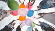 © Довидович Михаил - Cheerful girlfriends connect large colorful balls in a circle.