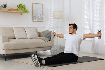 Sticker - Overweight man doing exercise with dumbbells on mat at home, space for text