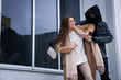 © New Africa - Woman fighting with thief while he trying to steal her bag near building, space for text. Self defense concept