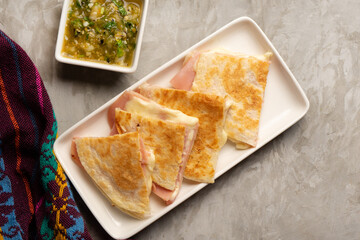 Wall Mural - Ham and cheese quesadilla with flour tortilla. Mexican food
