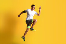 Sporty Male Runner On Color Background