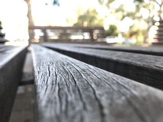 Wall Mural - Selective focus of a wooden texture surface of a bench with a blurry background