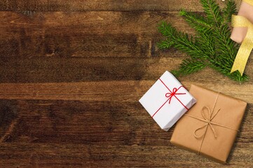 Poster - Christmas gift box with fir tree over rustic wooden background. Christmas and New Year background