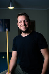 Poster - Closeup shot of a Hispanic male playing billiard in a bar in Argentina