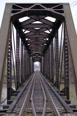 Poster - Perspective view of a metal railroad bridge on a river