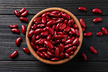 Raw Red Kidney Beans And Bowl On Dark Wooden Table, Flat Lay