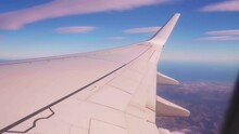 Airplane Wing Tilting Up Into The Horizon