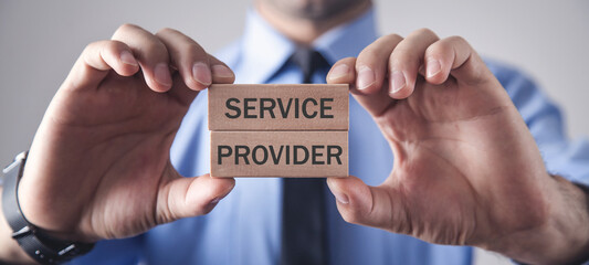 Wall Mural - Man showing Service Provider text in wooden blocks.