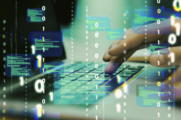 Leinwandbilder - Close up of hands using laptop keyboard with abstract coding binary code hologram on blurry background. Artificial intelligence and development concept. Double exposure.
