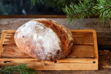 Wall Mural - Homemade sourdough bread. Wooden background, side view, horizontal