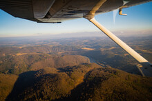 Beautiful Aerial View Of Countryside During Sunset From A Plane Window. Selective Focusing With Shallow Depth Of Field