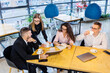 © Дмитрий Ткачук - Meeting of business people, discussing new business ideas, using diagrams, sitting together. Modern office background. Meeting of business partners at a business development conference