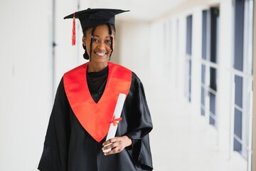 Wall Mural - beautiful african female student with graduation certificate