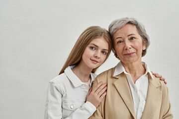 Wall Mural - Granddaughter hug senior woman on white background