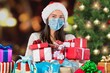 © BillionPhotos.com - Easy to buy with online shopping! Satisfied girl with medical mask holding Christmas present,