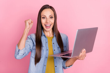 Poster - Photo of brunette cool young lady hold laptop yell wear jeans jacket isolated on pastel pink color background