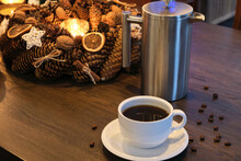 Cup Of Black Coffee And French Press On Festively Decorated Dark Wood Table