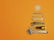 © BillionPhotos.com - Christmas tree made of construction tools with a snowflake on a background. New Year's concept for a car workshop.