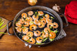 Fried peeled prawns in a pan with onions and garlic, rustic style