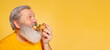 © master1305 - Flyer. Close-up senior bearded man enjoying taste of pizza isolated on yellow studio background. World pizza day