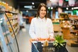 © Serhii - Young woman shopping in the supermarket