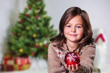 Canvas Print - Young girl decorating a Christmas tree, Coronavirus and Christmas concept, beautiful holiday background